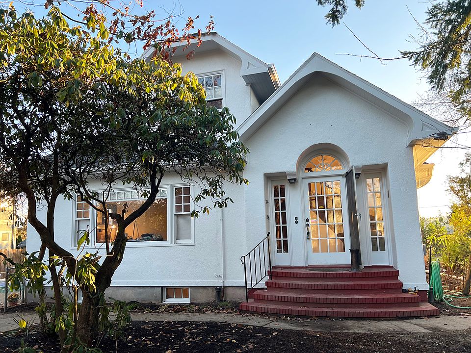 Duplex's charming front entry opens into upstairs and downstairs living spaces.