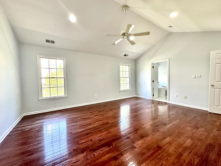 Beautiful Primary Bedroom with Cathedral Ceiling and beautiful cherry floor