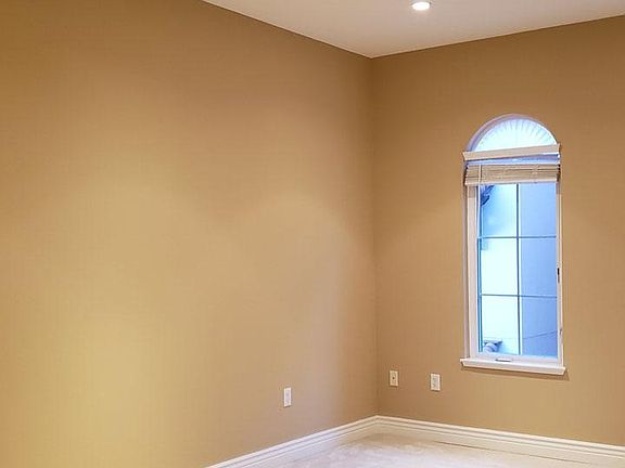 Master bedroom with recessed lighting.