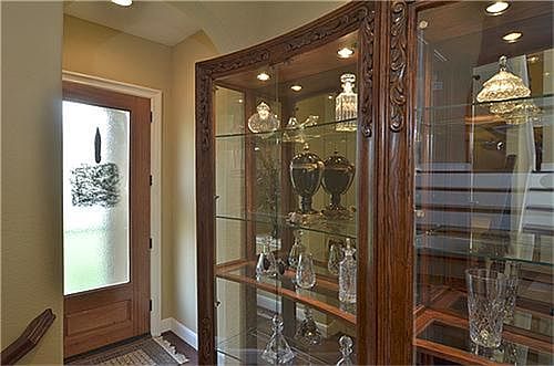 A glass door opens to the foyer with tile floor.