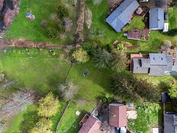 Picture showcases the large 1.1 acre lot. At the bottom of the lot-Home meets the creek with 117 feet access to May Creek. 