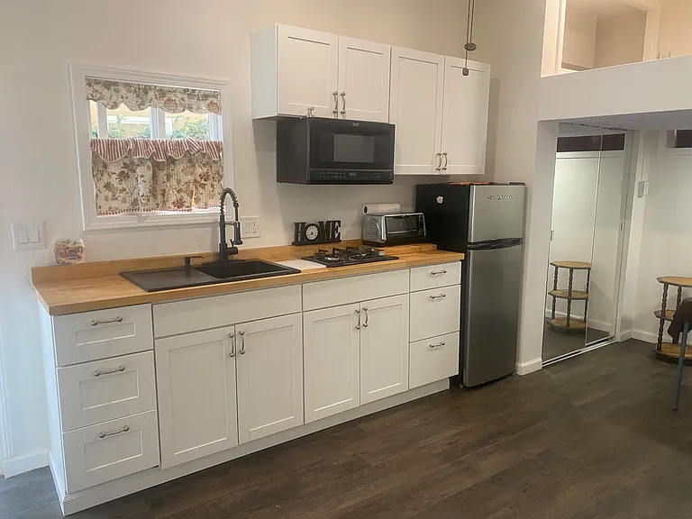 Kitchenette includes built-in microwave, toaster oven, refrigerator, butcher block counters.