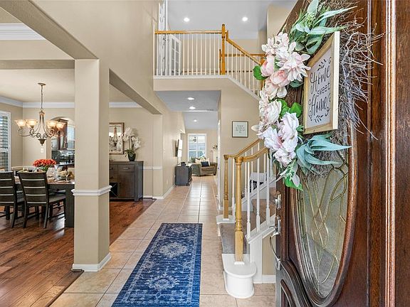 Two story entry with dramatic staircase.