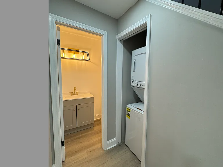 Main floor bathroom and stacked washer dryer unit.