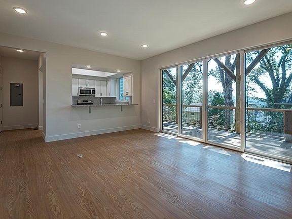 Large living room, with kitchen in background