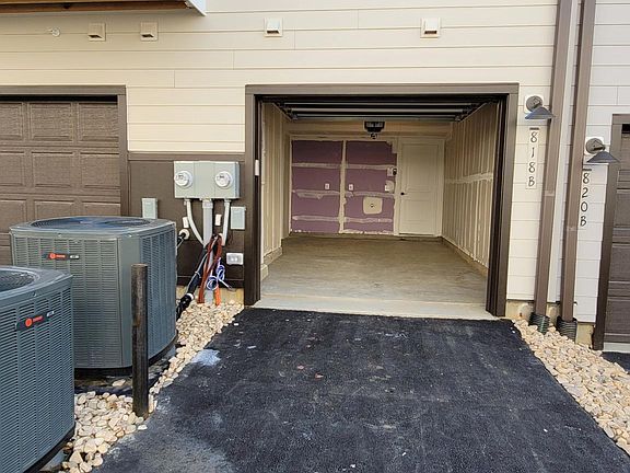 Single car garage on the back of the building with drive way