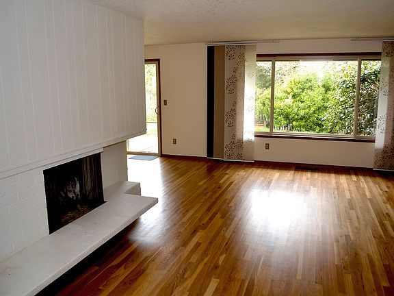 Freshly painted and refinished hardwood with fireplace in th