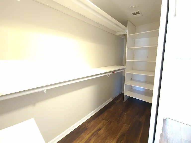 Primary bedroom walk in closet #1