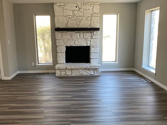 Freshly painted fireplace and mantle. Vinyl plank flooring throughout.
