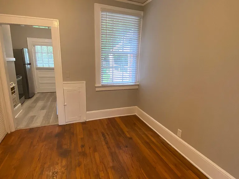 Dining room with kitchen in background.