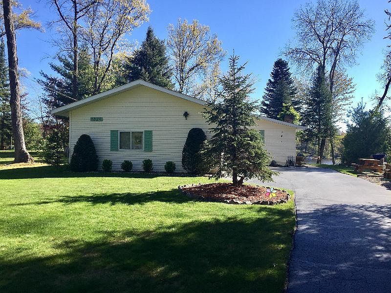 Beautifully remodeled waterfront home with partially finished full walkout basement that includes a workshop.  This 3 bedroom 2 bathroom home comes with many recent updates including a knotty pine ceiling, updated kitchen, bathroom, new paint, entry doors, storm doors and new well in 2012.  There is an attached two car garage along with another attached garage for your toys or up to a 20' pontoon.  Enjoy the lake in the summer time and the wood fireplace in the winter.  In addition, the underground sprinkler system will maintain your lawn when gone.