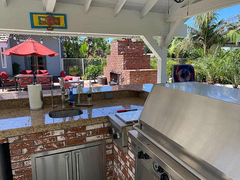 Spacious covered outdoor kitchen with fridge and pebble ice maker_perfect for al fresco dining in sunny Cucamonga!