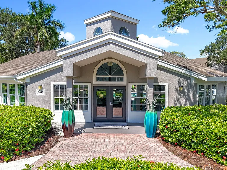 Bright windows, lush greenery, and charming coastal architecture greet you at the River Reach leasing office.