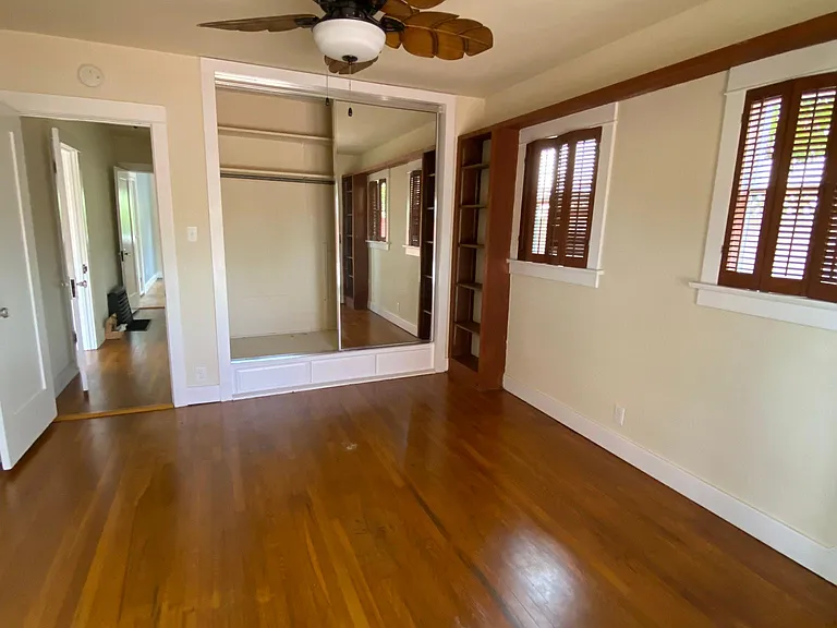 Bedroom w brown trim has a sunroom and patio