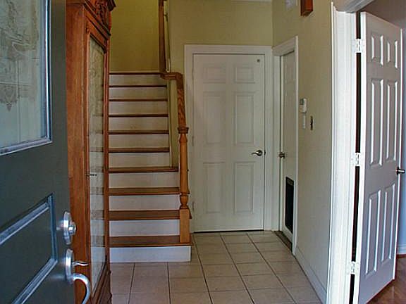 Welcome! The tiled entry foyer leads past bedroom #3 (with double doors) to the stairway or the elevator which is the door next to the stairway.