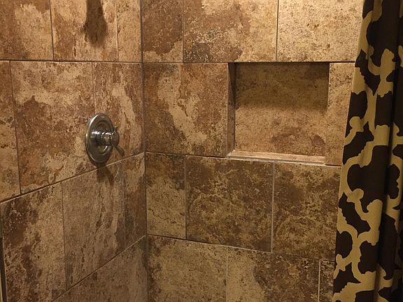 Tiled shower in bathroom