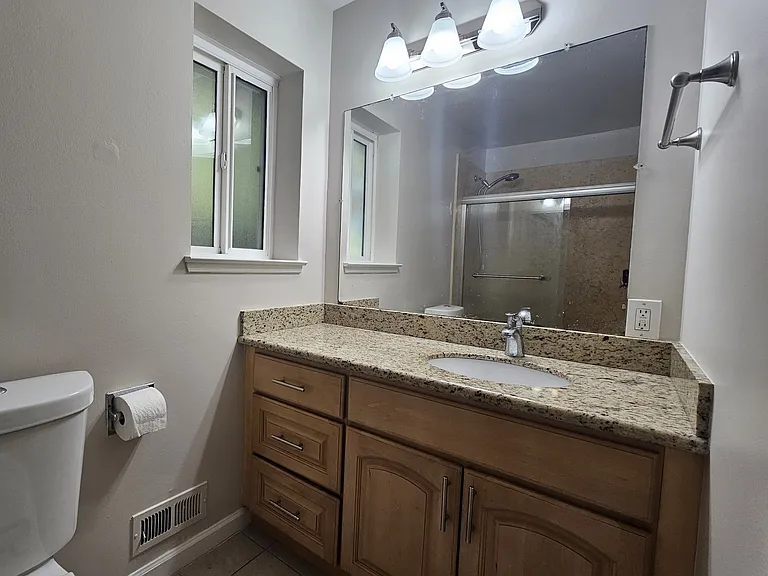 Full bath with shower over tub and glass enclosure