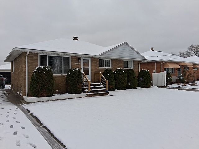Outside of house. All brick with a 2.5 car garage.