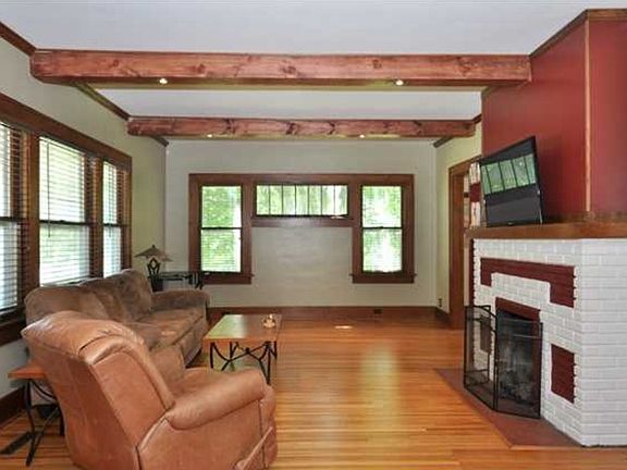 Step into the spacious living room, with wood beams and a fa