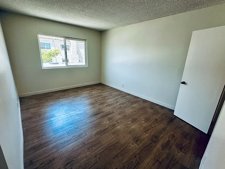 Master Bedroom (Before Blinds Installed). Closet to the right. The unhung closet door is shown to the right.