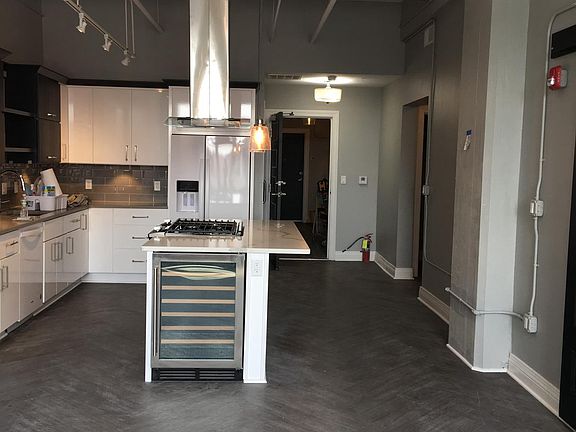 LED integrated chandelier with view of kitchen island and Wi
