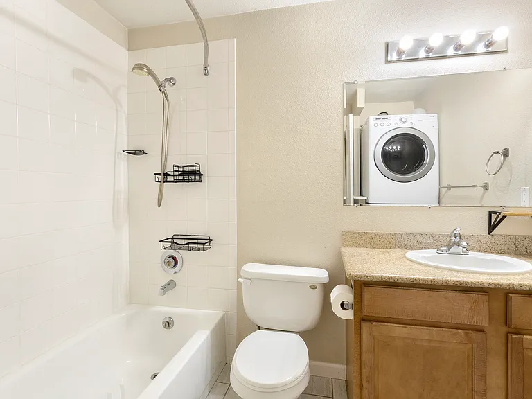 Hallway full bath with washer and dryer