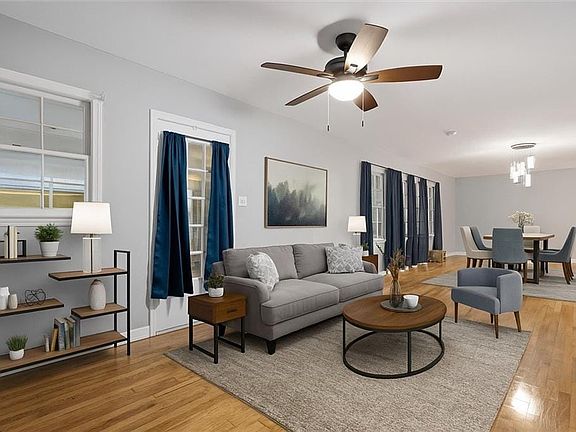 Virtually staged unroom / solarium featuring brick wall