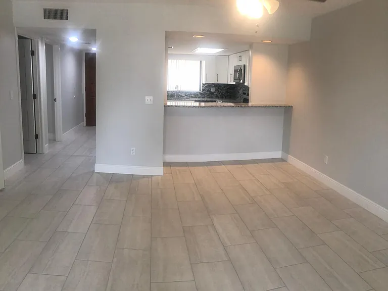 Looking from living room area towards dining and kitchen area.