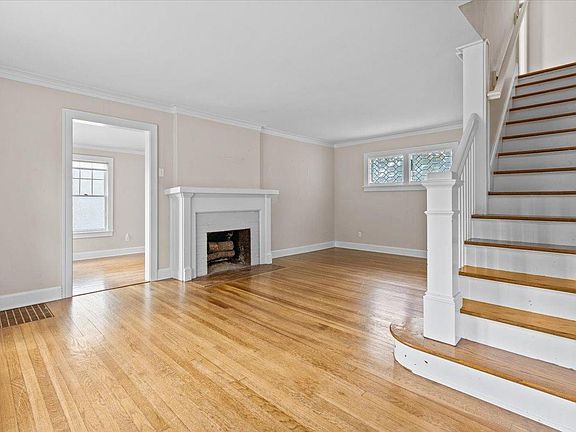 Inviting living room with decorative fireplace and leaded glass windows.