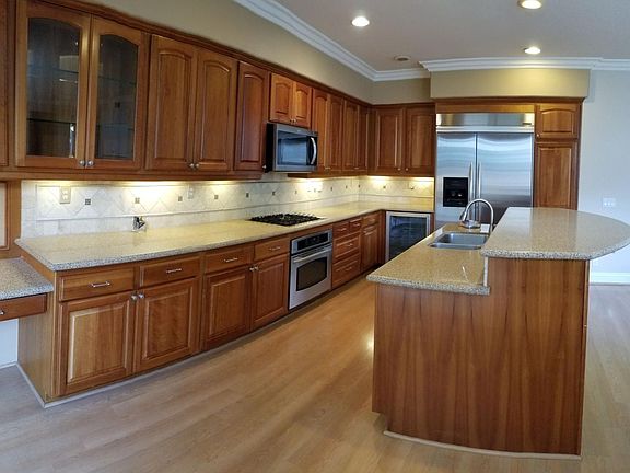 Kitchen with built in refrigerator, beverage cooler, gas stove, range, microwave and dishwasher