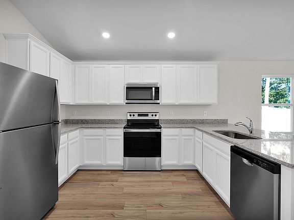 Enjoy stunning granite countertops and designer cabinetry in this kitchen.
