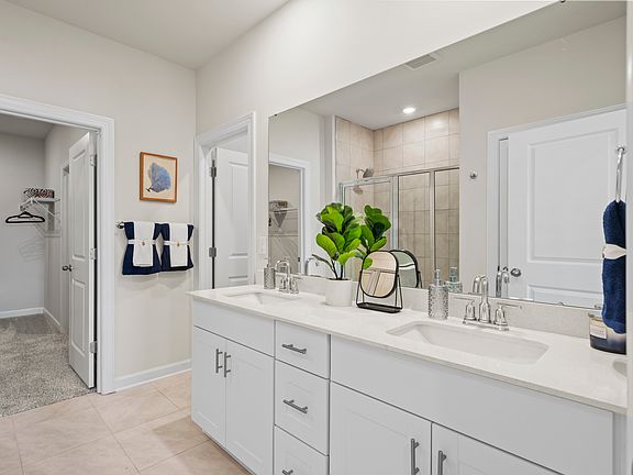 The primary bath offers dual vanity sinks and a walk-in shower Clear Pond in Myrtle Beach, SC