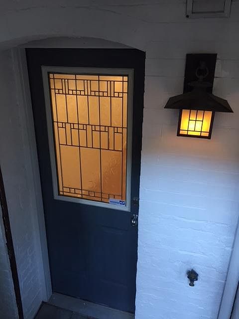Front door of English basement unit