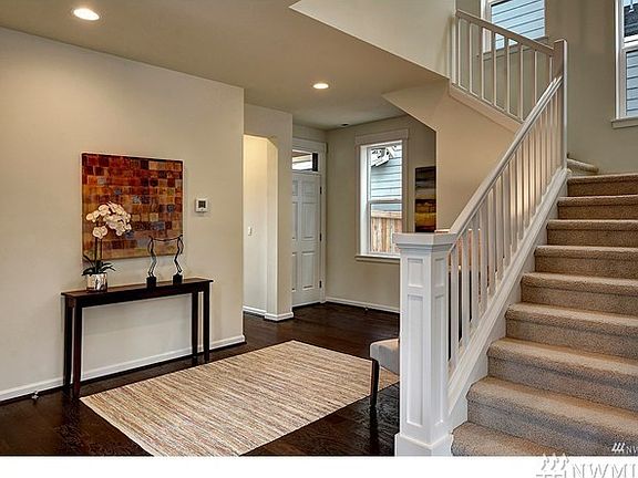 Foyer with gorgeous staircases that lead to upper and lower levels. Photo not of actual home - may contain optional features.
