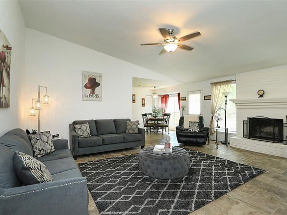 There's a spacious family room with fireplace and high ceilings