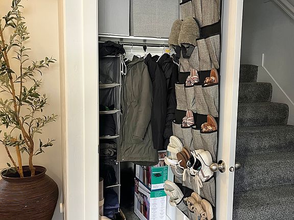 1st floor - coat closet that extends under the stairs