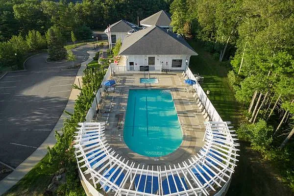 Resort-Style Pool with Pergola and Chaise Lounge Chairs