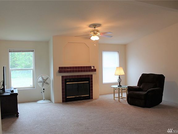 Nice big living room with a wood-burning fireplace!  Windows look out over the expansive back yard.  The Master bedroom is to the right, and the other bedrooms are to the left, and the kitchen is right behind me.