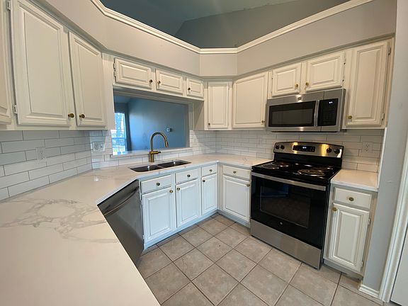 New quartz countertops, Freshly painted cabinets inside and out, subway tile backsplash, Stainless steel appliances, separate pantry.