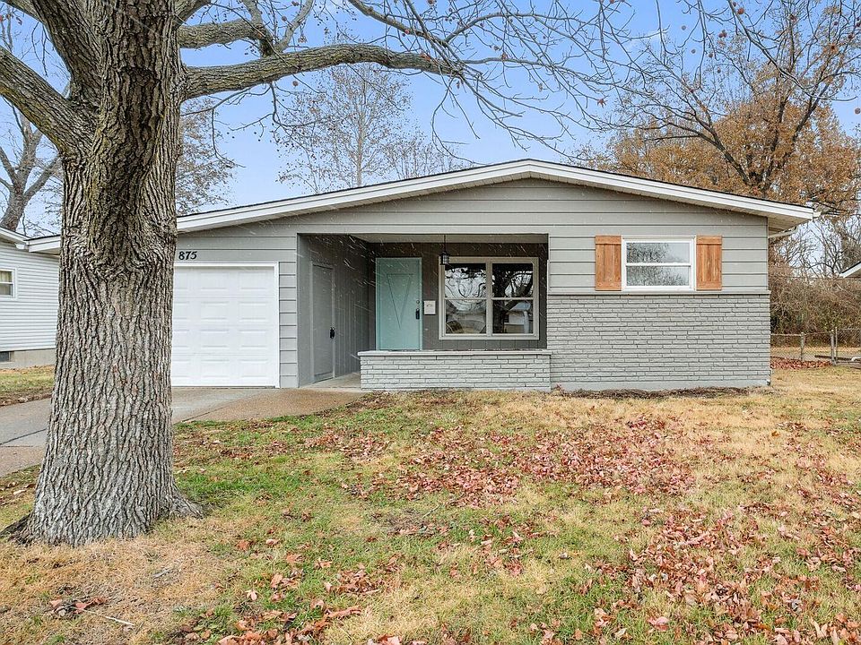 Large, covered front porch welcomes you to 875 Carmelita Ln with brick front, new shutters, 1 car garage and newer architectural