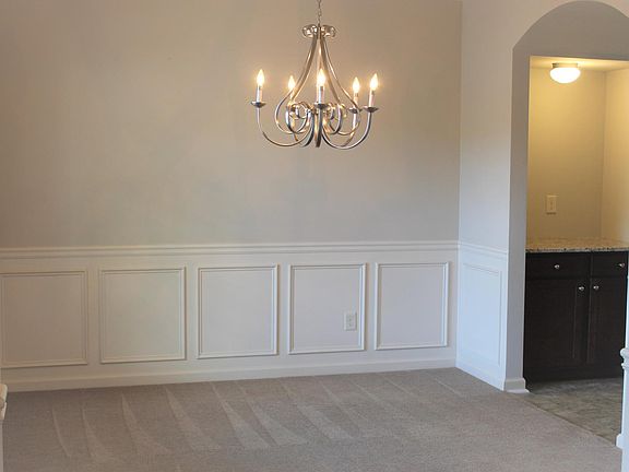 Dining room and arched entry to kitchen through butlers pantry