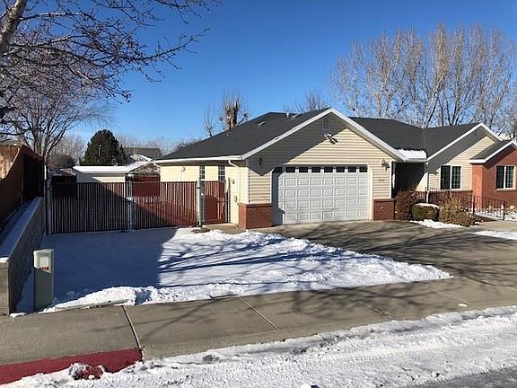 Front of home with secure fenced RV/Trailer Storage