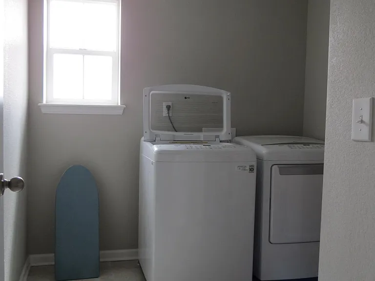 Laundry room on second floor with linen closet