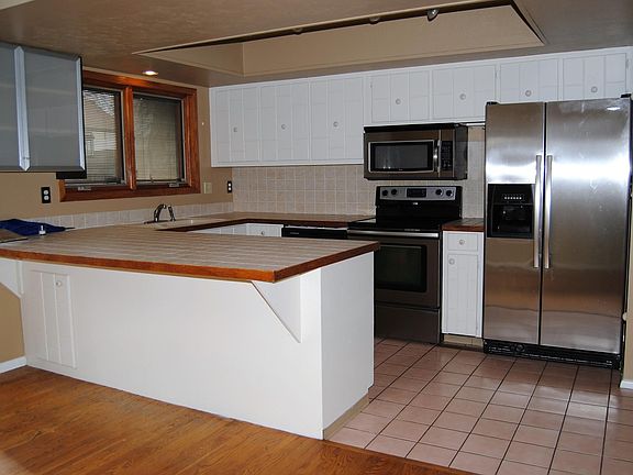 Kitchen With Breakfast Bar and Nice Appliances
