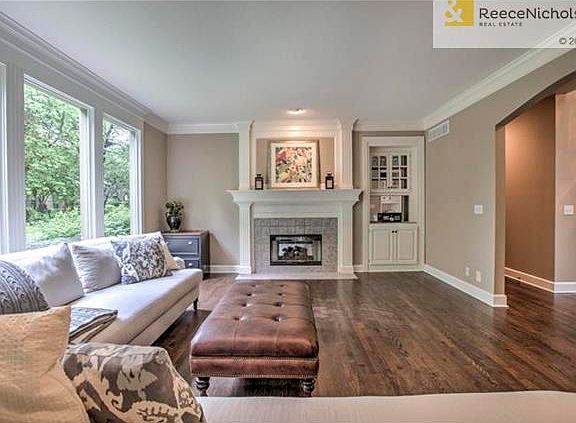 Formal living room has a wall of windows overlooking the spectacular yard.