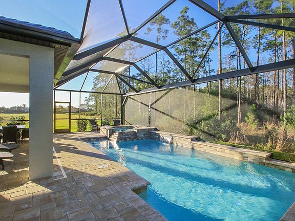 Model Representation Enjoy extra entertaining space with a spacious screen lanai with custom pool a
