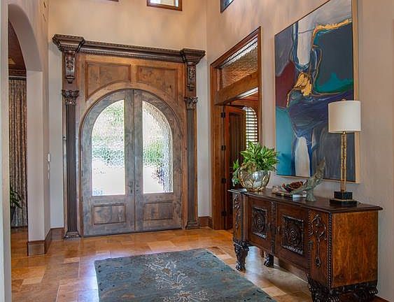 From the moment you enter, you'll know that this home is something very special. Gorgeous knotty alder woodwork is found throughout the home. This is travertine flooring.