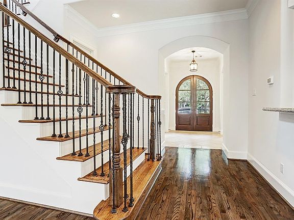 Another view of the entry looking back from the staircase and open to the family room and kitchen