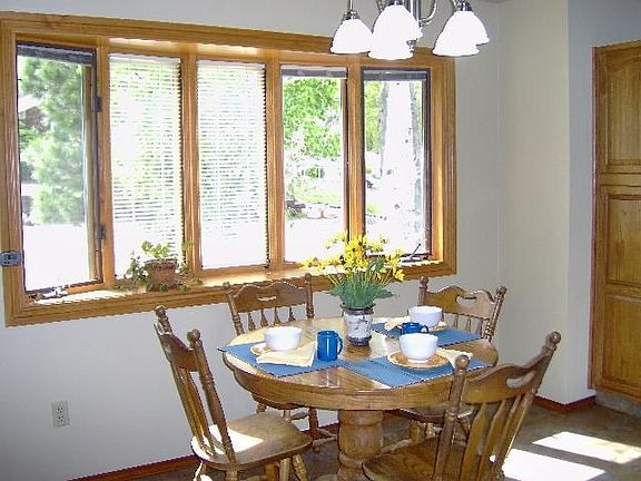 Eat-in area of kitchen with bay windows.