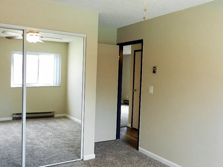 Experience comfort in this elegantly designed bedroom, featuring a modern ceiling fan and ample natural light. Experience comfort in this elegantly designed bedroom, featuring a modern ceiling fan and ample natural light.
